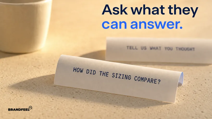 A macro view of a thermal receipt curling on a warm kitchen counter, one printed question legible across its width and the rest of the roll blank and unrolled behind it